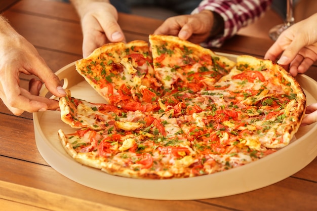 Group of friends eating pizza