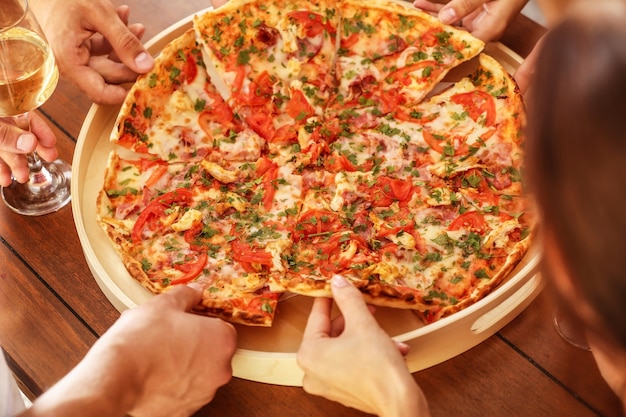 Group of friends eating pizza