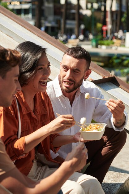 Group of Friends Eating Street Food