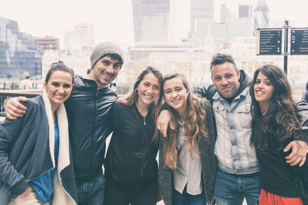 Group of friends embraced together in London.