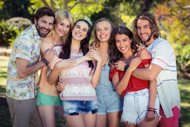 Group of friends embracing in park