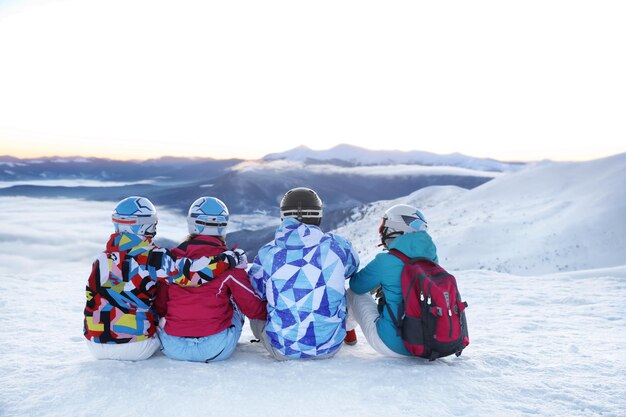 Group of friends enjoying the beauty of snowy ski resort Winter vacation