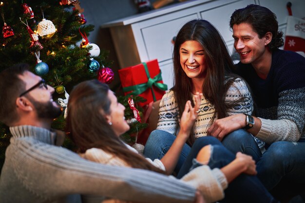 group of friends exchanging Christmas presents at home