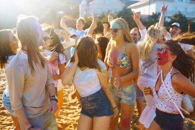 A group of friends have fun dance at the holi festival Celebrating traditional indian spring holiday Friendship