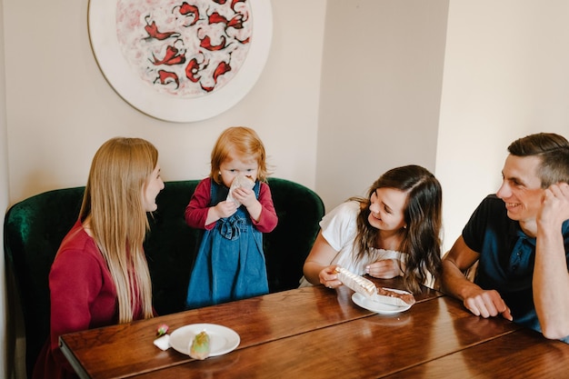 Group of friends have fun time together Women child and man at cafe talking laughing and enjoying their time Celebrate Happy Day 8 March