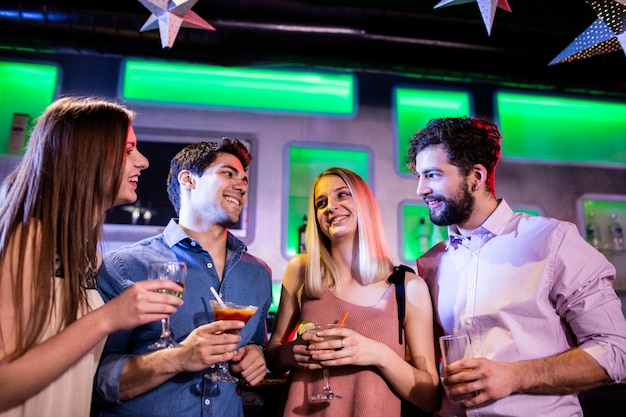 Group of friends having cocktail and wine