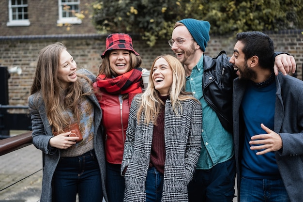 Group on friends having fun around the city in winter time - Focus in center girl face