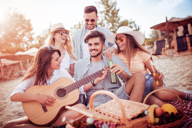 Group of friends having fun at the beach