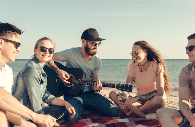 Group of friends having fun on the beach