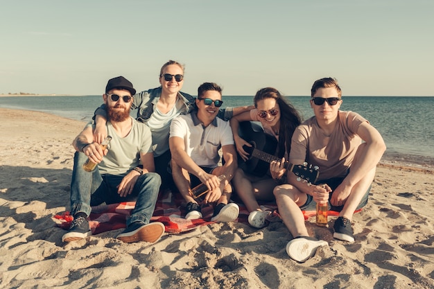 Group of friends having fun on the beach