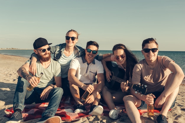 Group of friends having fun on the beach