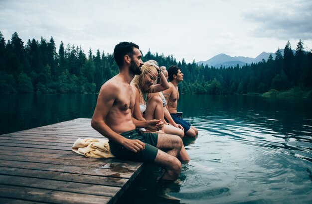 Group of friends having fun at the lake in the morning