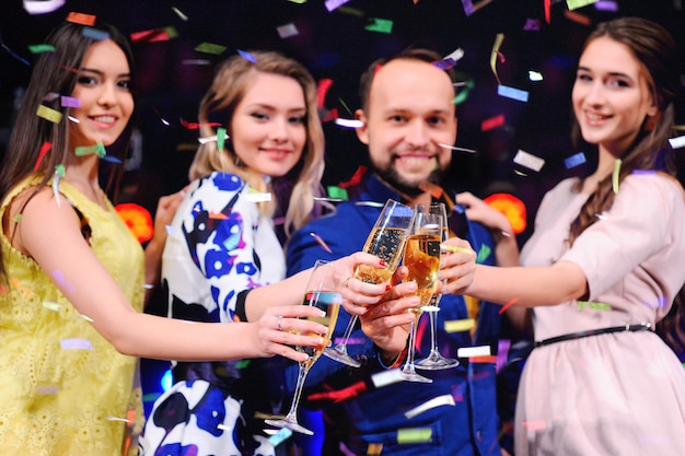 Group of friends having fun at the party with a glass of wine or champagne