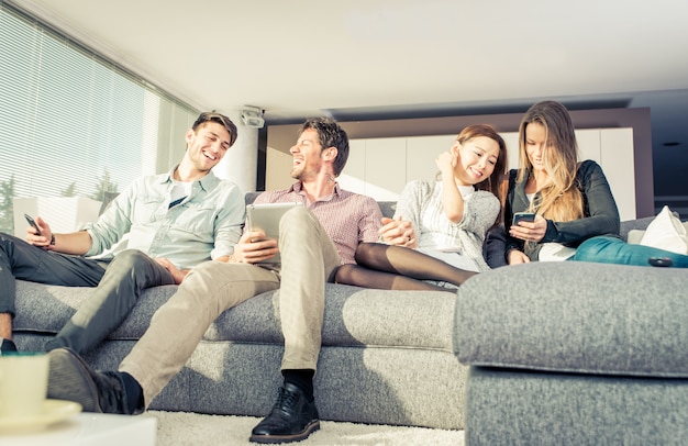 Group of friends having fun and spending time together at home