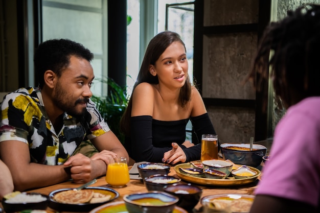 A group of friends having a meal and talking