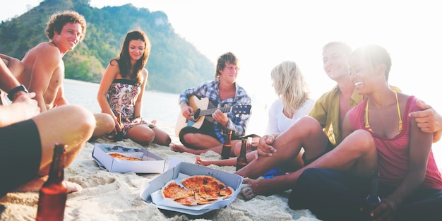 Group of friends having a summer beach party.