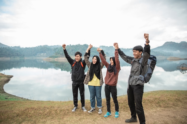 Group of friends on hiking enjoy lake view