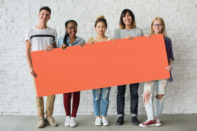 Photo group of friends holding blank banner