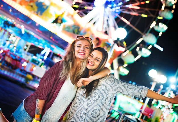a group of friends is enjoying the amusement park