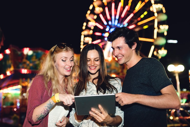 A group of friends is enjoying the amusement park