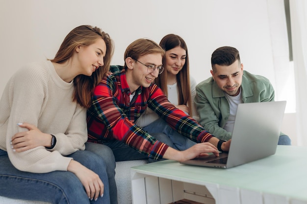 Group of friends looking at something on a laptop computer