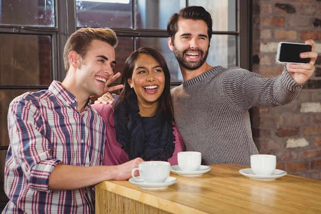 Group of friends looking at their smartphone