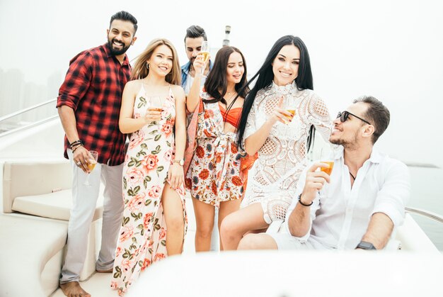 Group of friends making party on a yacht