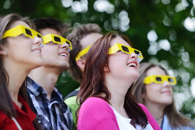 Group of friends in the park wearing 3d glasses