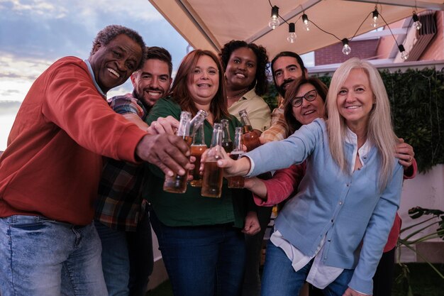 Group of friends at a party together toasting with beer Concept fun toast friendship