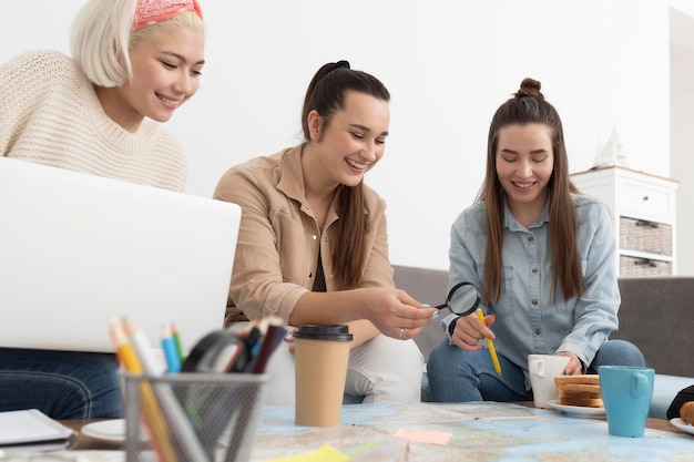 Photo group of friends planning a trip with a map