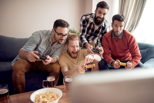 Group of friends playing digital games at home