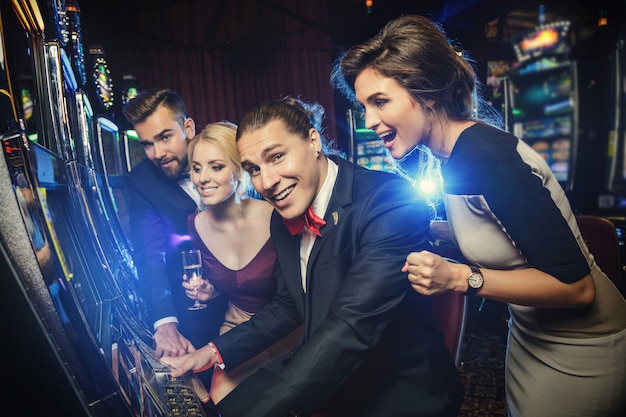 Group of friends playing slot machines