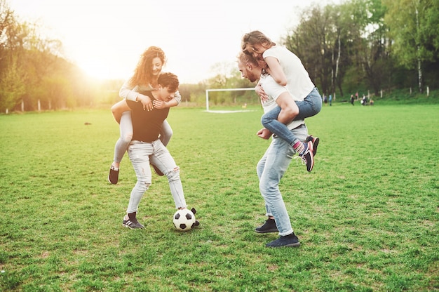 A group of friends plays soccer in the open air