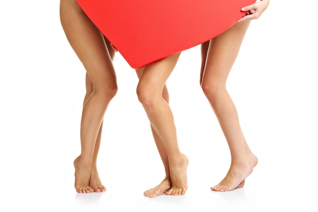 Photo group of friends posing naked with heart over white background