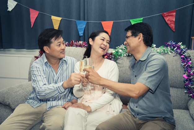 Group friends of senior man and woman happy party with champagne at home