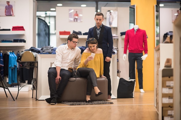 group of Friends On Shopping Walk On Shopping Centre using a mobile phone for ideas