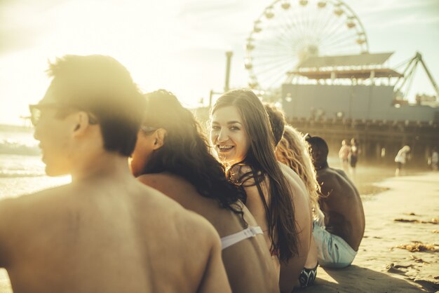 Group of friends sitting on the beach