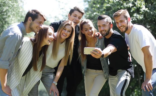 Group of friends takes a selfie on the background of the city Parkpeople and technology