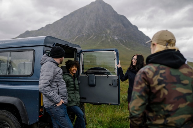 Group of friends taking break while on a road trip