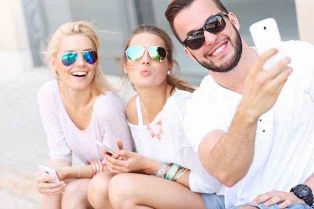 group of friends taking selfie in the city