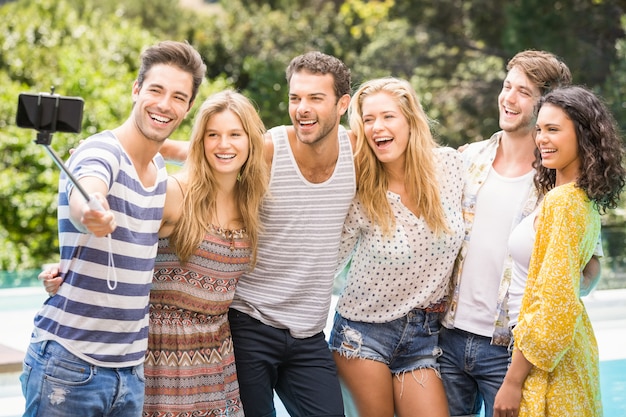 Group of friends taking a selfie near pool