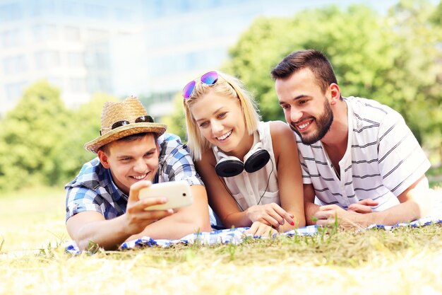 a group of friends taking selfie in the park