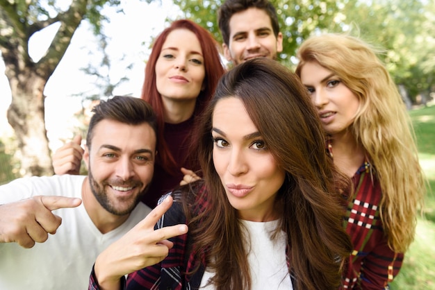 Group of friends taking selfie in urban background