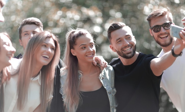 Group of friends taking selfies in the Park