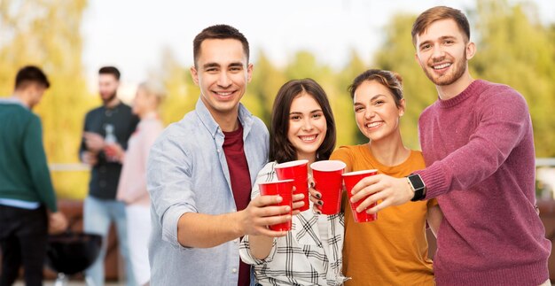 group of friends toasting drinks at rooftop party