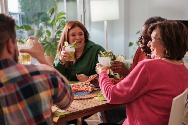 Group of friends toasting and eating together to celebrate life Concept lifestyle together fun