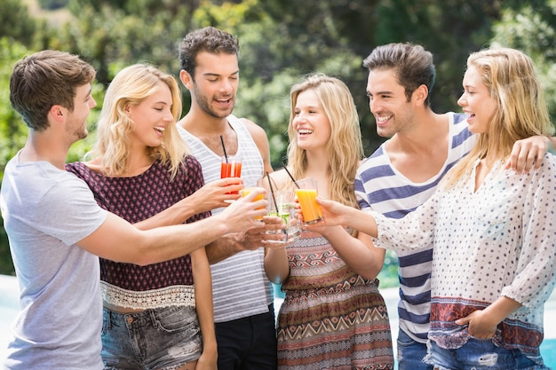 Group of friends toasting their juice glasses