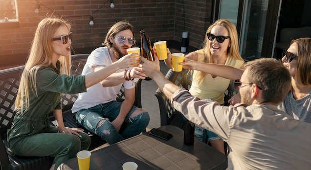 Group of friends touch glasses as