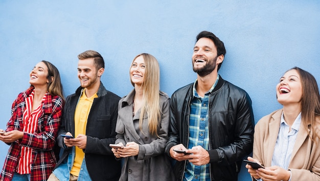 Group of friends using smart mobile phones