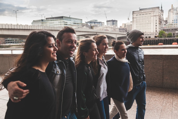 Group of friends walking and having fun together in London